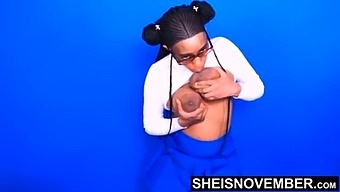 Chesty Ebony Model Sheisnovember Enormous Areolas & Nipples Dangling On Massive Udders Squeezed Then Licked During Photography Session Lifting Her Shirt Revealing Perfect Saggy Rack, Sitting On A Stool  In A Blue Mini Skirt By Msnovember