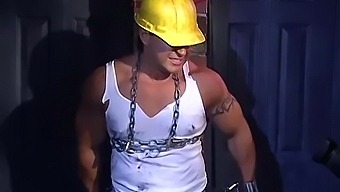 Muscular Construction Worker Is Bound Up With Chains