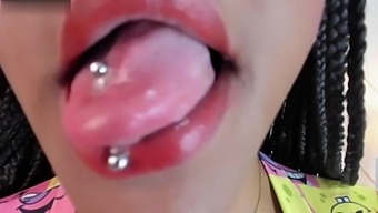 Close-Up Of A Latina'S Ebony Body And Teasing With A Pierced Tongue